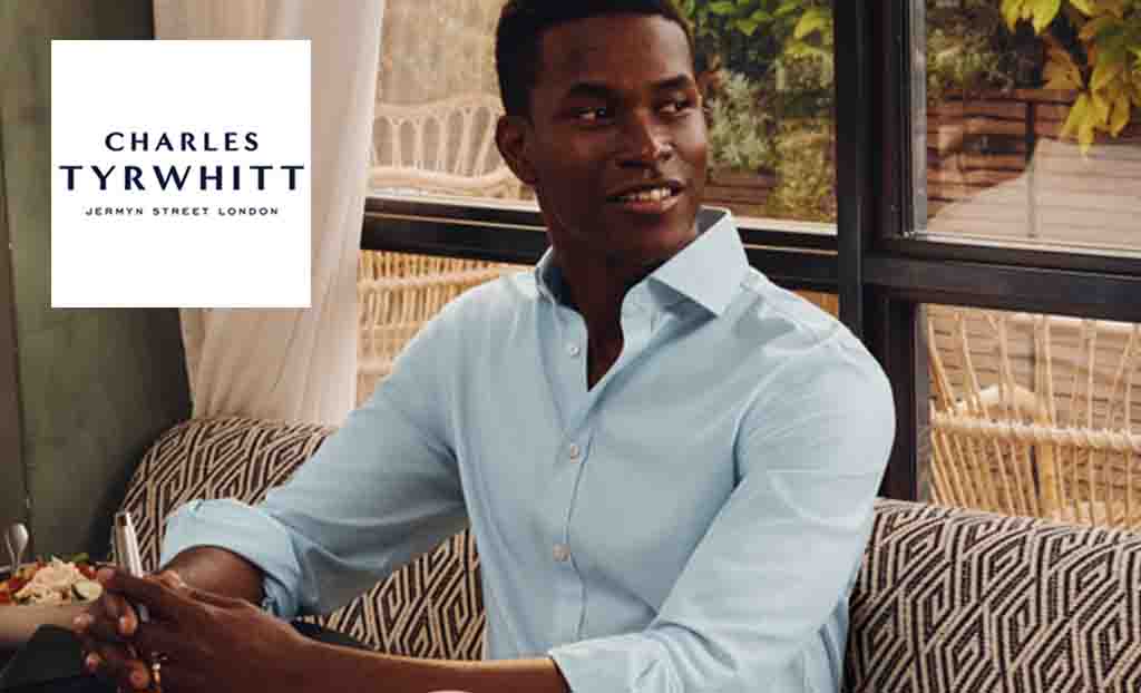 Charles Tyrwhitt logo placed over an image of a man posing with baby blue shirt 